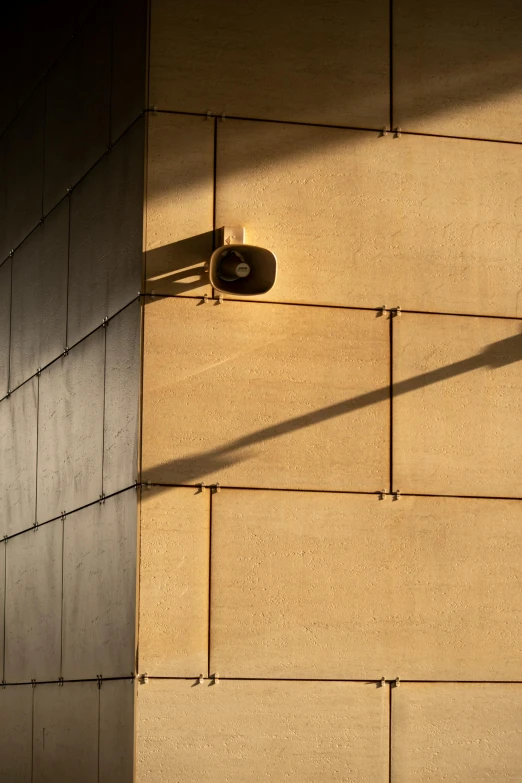 the street light is attached to the wall of a building