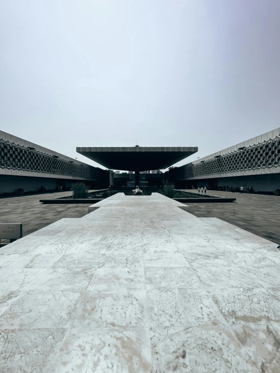 a long cement road surrounded by large building