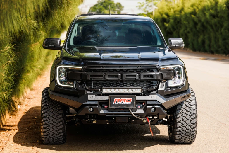 a black truck parked on the side of the road