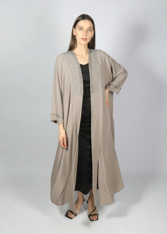 woman wearing long grey cardigan and black dress