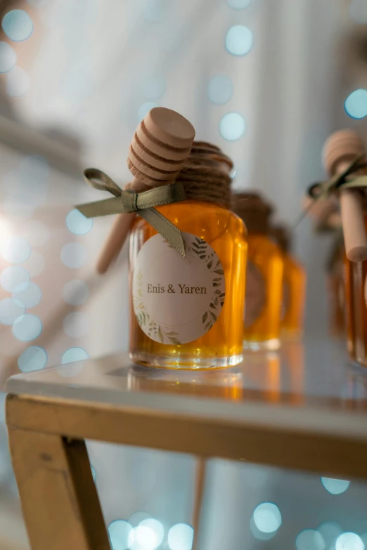 two jars with honey on top of a table