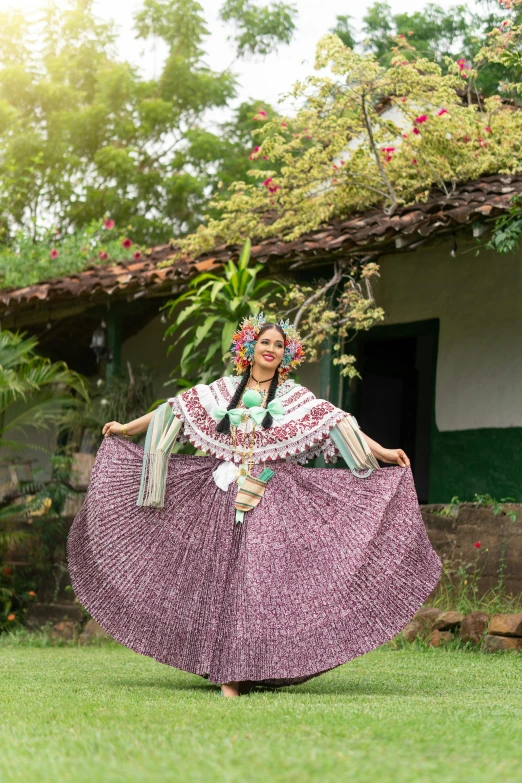 a woman in an ornate dress dancing in the yard