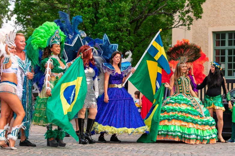 women in costumes are holding flags and smiling