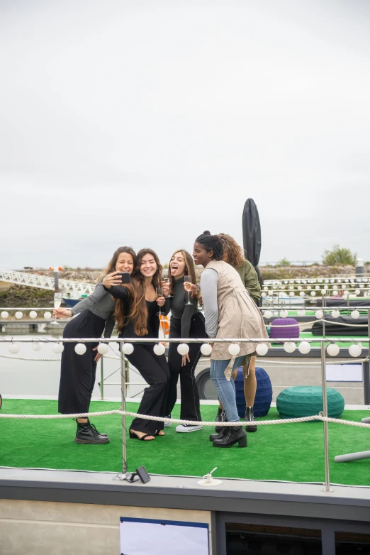 three women on a boat taking pictures