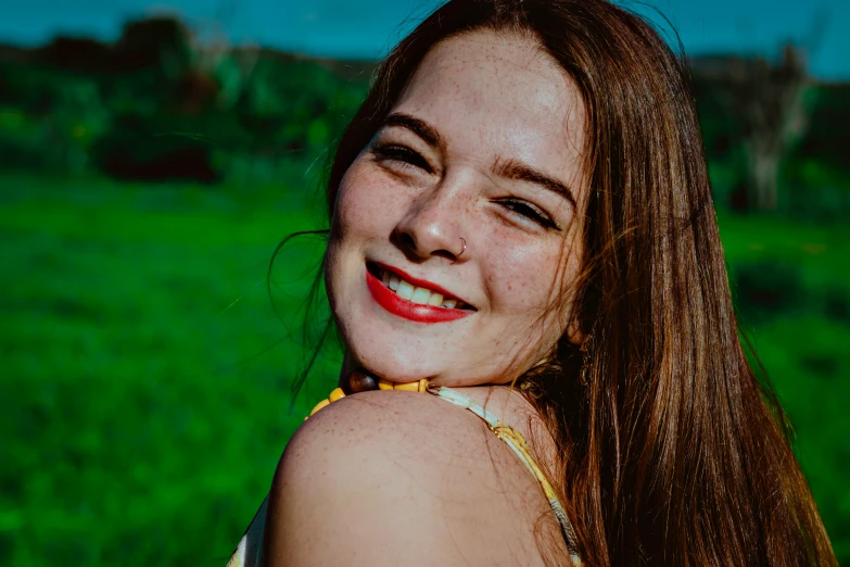 an image of a girl smiling on a field