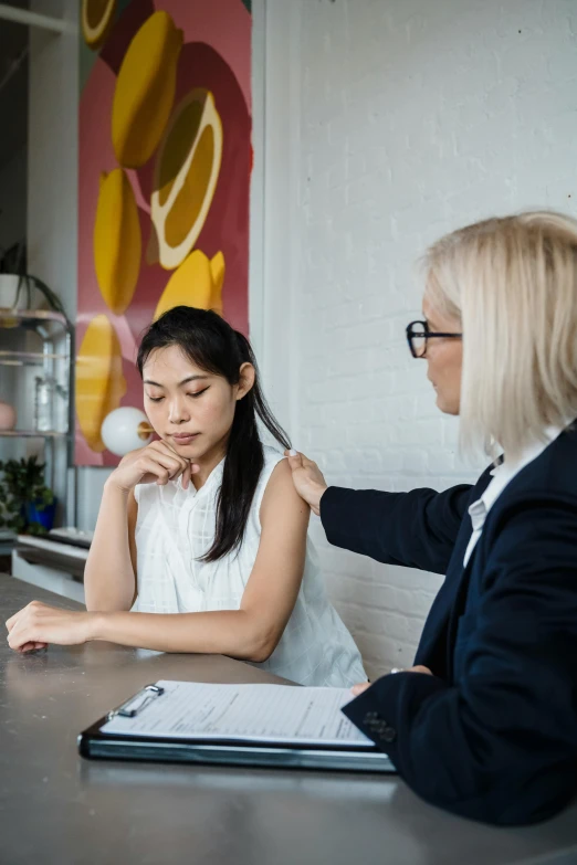 two women having conversation at the counter