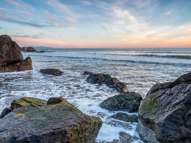 rock formations with small waves coming in to the shore