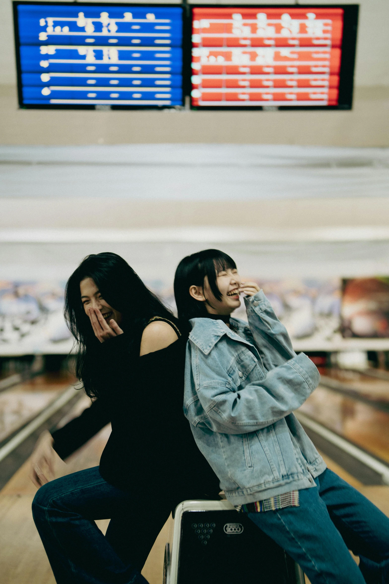 two women pose for a pograph while bowling