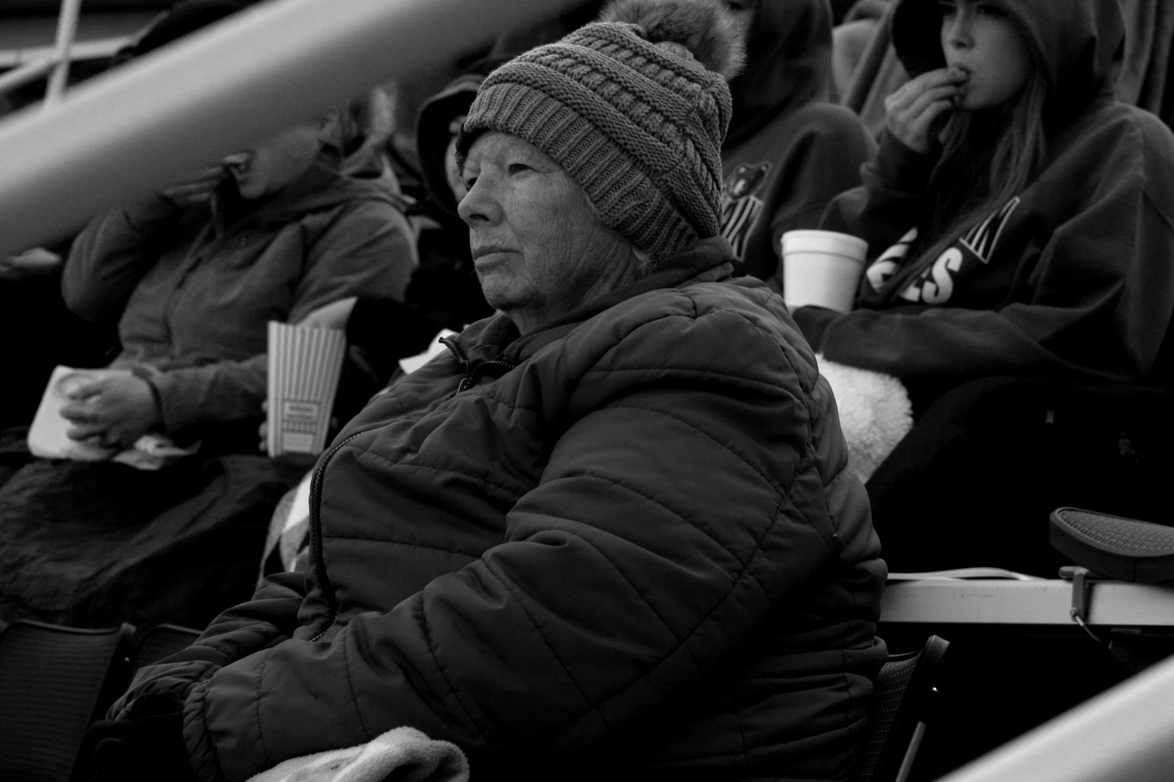 an old man and two s sitting in the stands