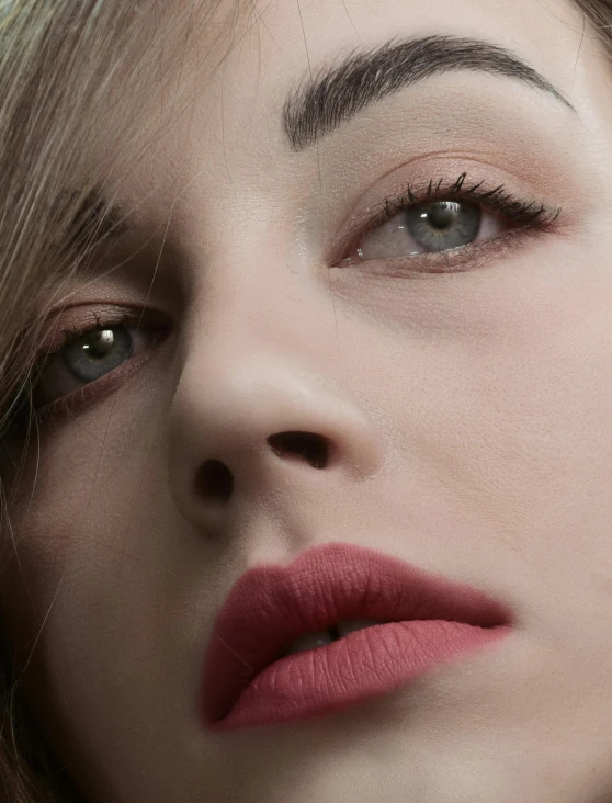 closeup on a beautiful young woman with red lipstick