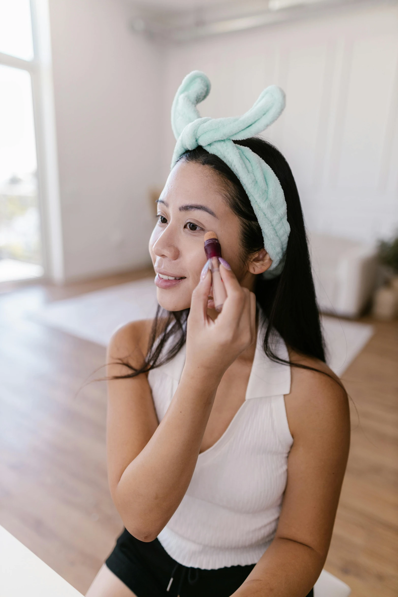 a woman with her nose covered in a mouse hat