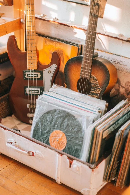 a close up of an open suitcase containing guitars