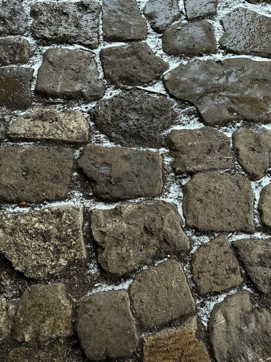 an old and worn, stone path has white and yellow markings