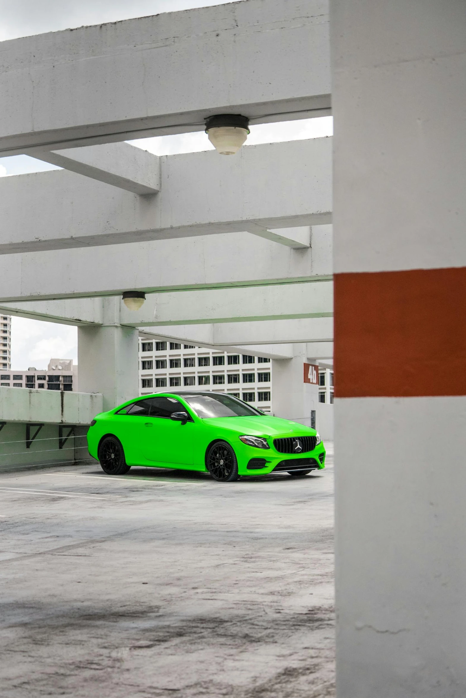 the green car is parked in the parking space