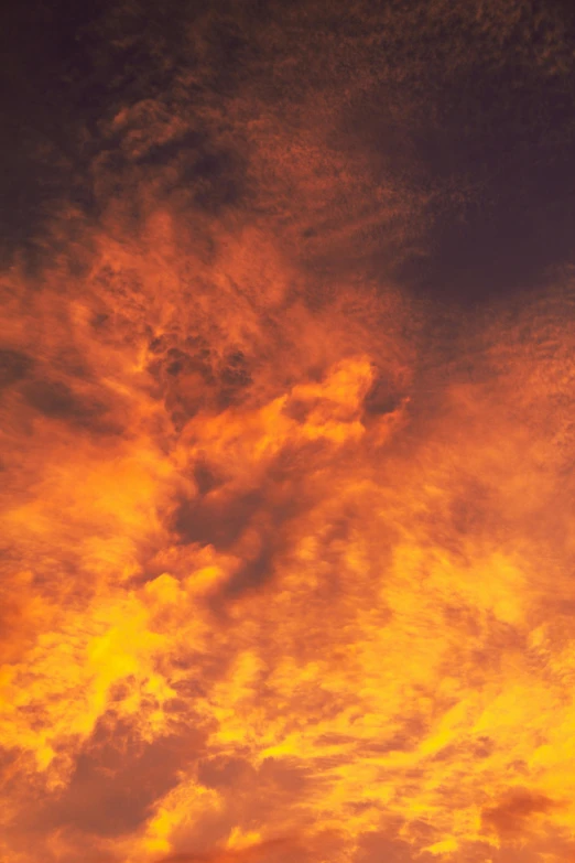 yellow, blue and orange clouds float across the sky