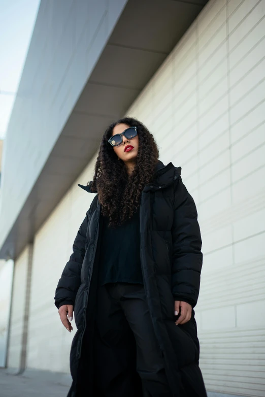 a person wearing sunglasses standing on the sidewalk