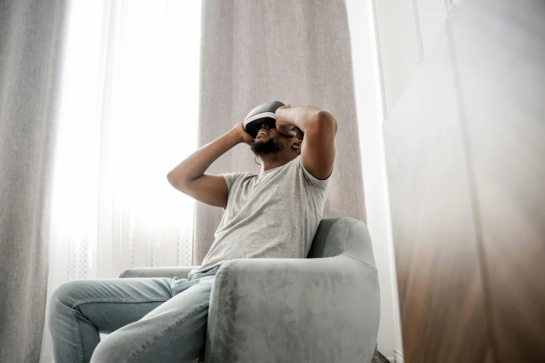 a man sitting in a chair with a cell phone