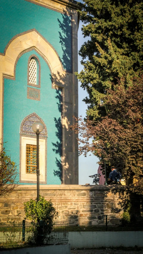 a blue building with white trim and a clock tower