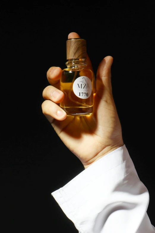 a woman holds an empty bottle of makeup oil