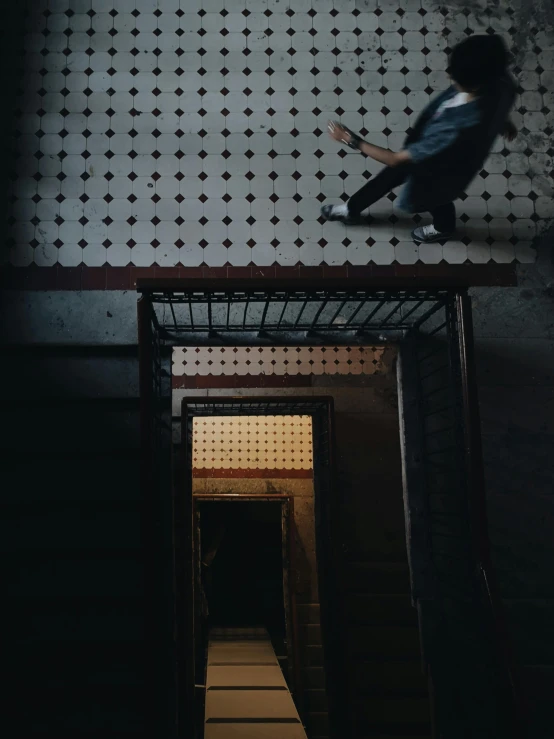 a man jumping over a set of stairs in the dark