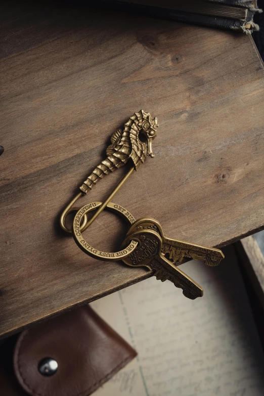 gold skeleton keychain on wooden table top