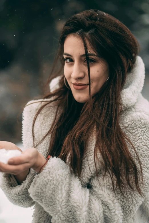 woman in a fuzzy coat in the snow