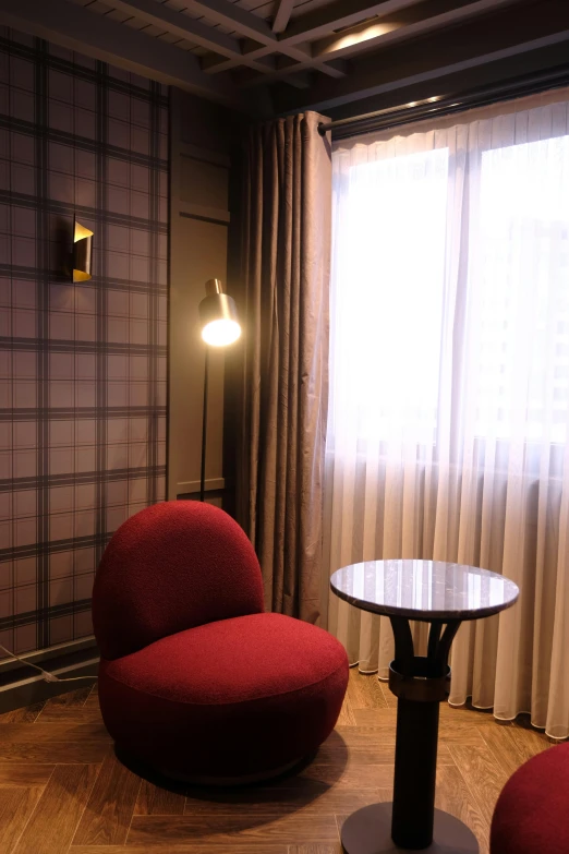 a small table with red chairs on the floor next to it