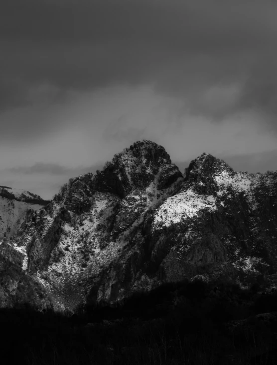 a snowy mountain covered in snow is shown in black and white