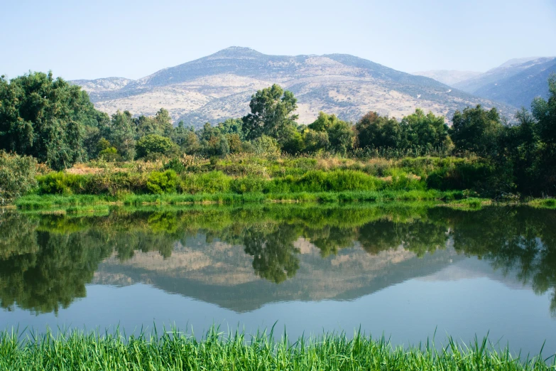 the mountains range are reflected in the river