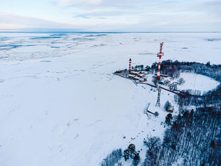 a small group of red poles sitting on top of a snow covered field