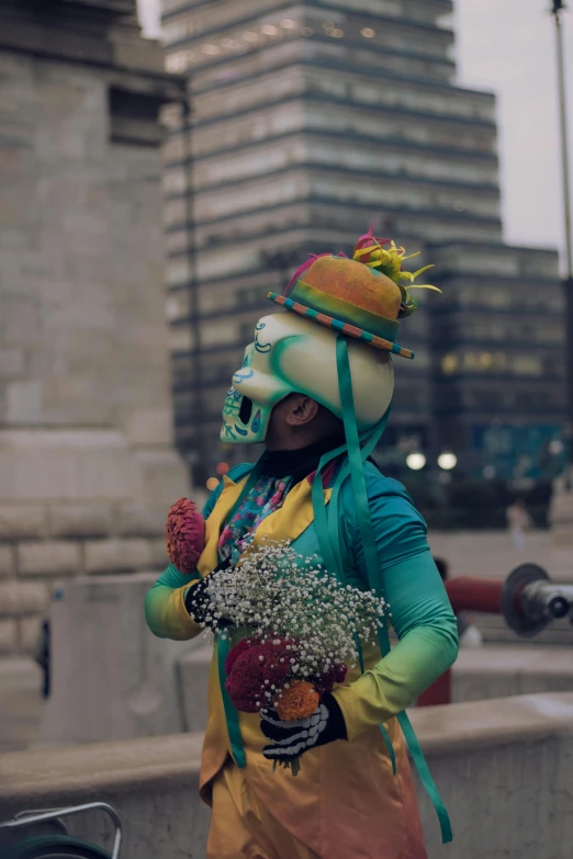 a person in a zombie costume walks near tall buildings