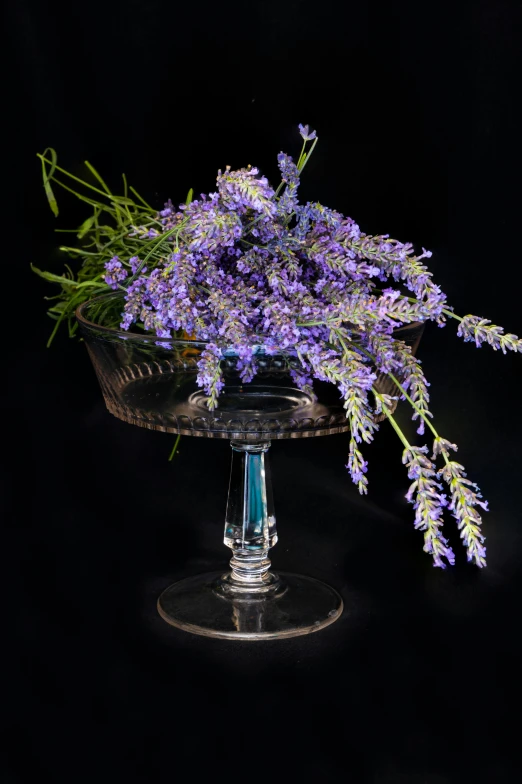 a bunch of wildflowers in a crystal bowl