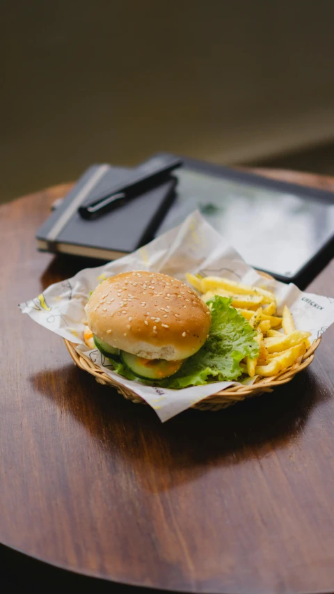 a meal of a hamburger and fries, with a drink on the side