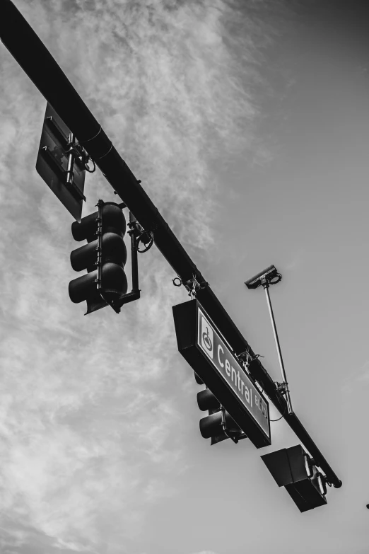 traffic lights on post against white cloudy sky