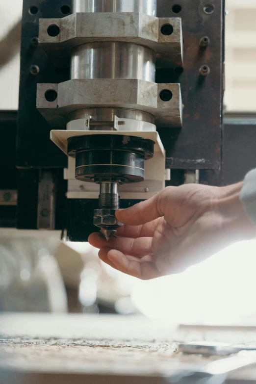 the person is working on the metal item