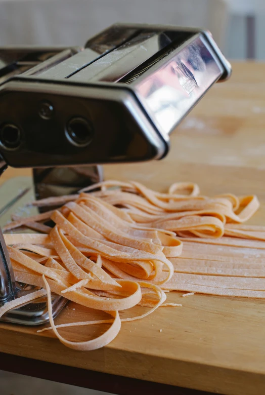 a plate of pasta being pulled by a manual device