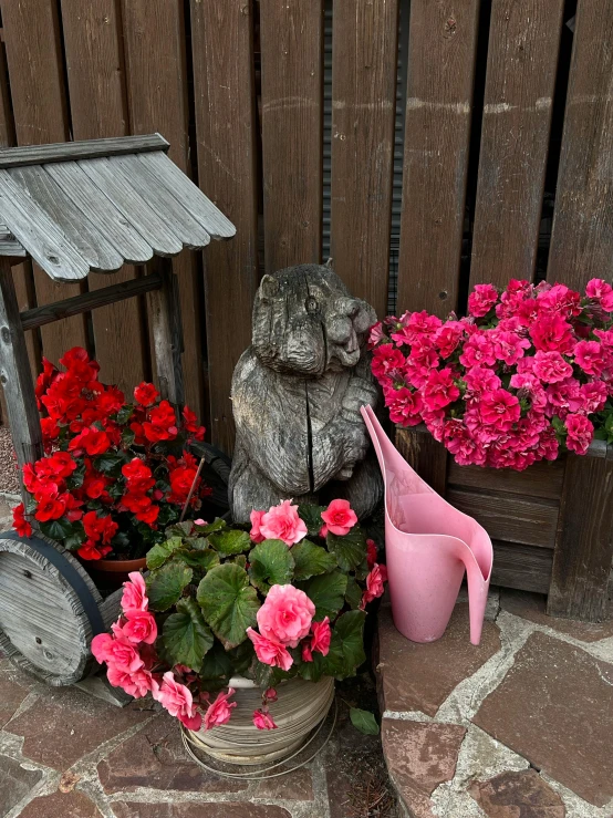 some flowers in baskets a metal planter and an umbrella