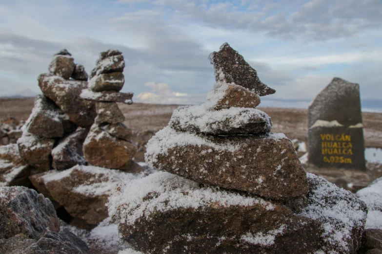 a few small rocks with snow on them