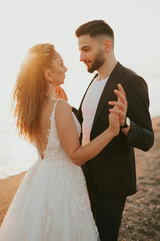 an engaged couple is having a good time on the beach