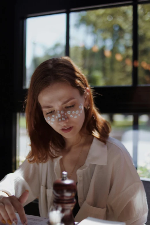 a woman with glasses has spilled onto a chocolate jar