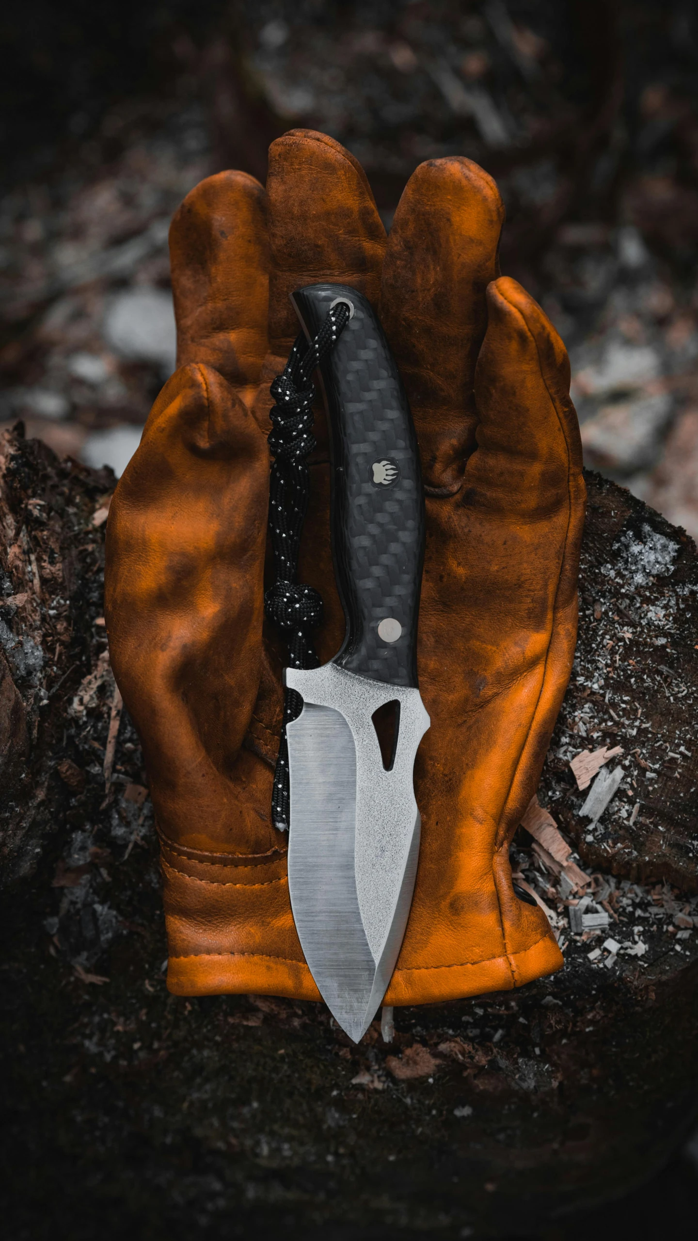 a leather glove with a knife inside of it