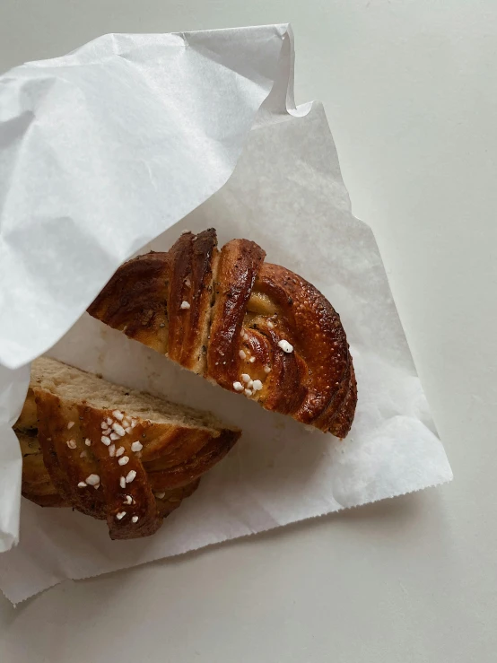 two pastries and one is on top of a paper