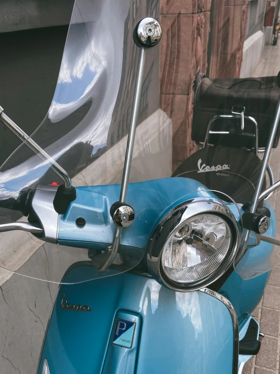 a moped is sitting in front of a building