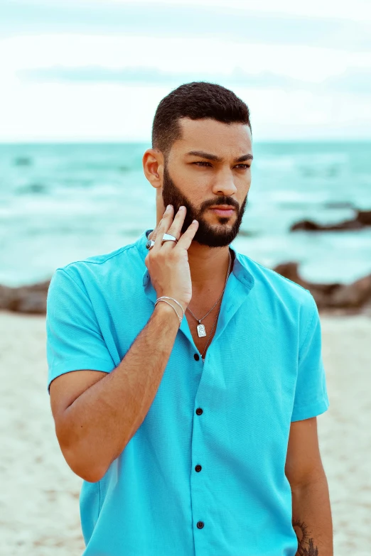 a man on the phone on the beach