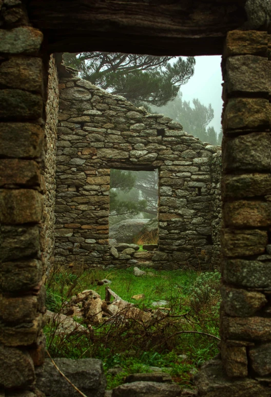 a couple of stone walls surrounding a field