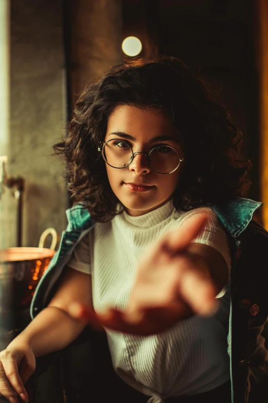 an image of a woman sitting down making a hand gesture