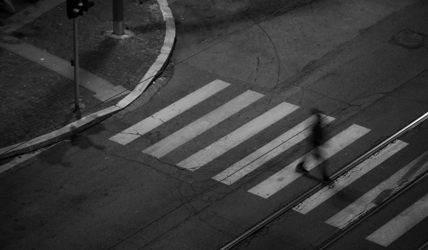 a street corner with a pedestrian on a crosswalk