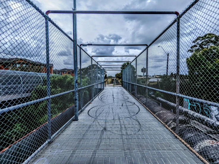 a walkway that is under some very cloudy skies