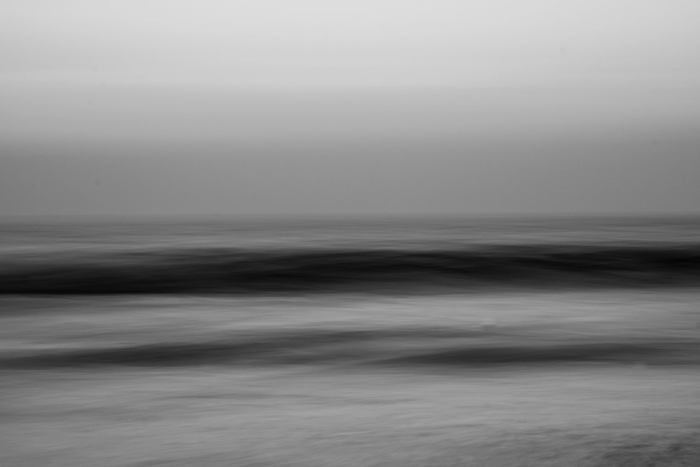 a gray sky is shown with blurry waves