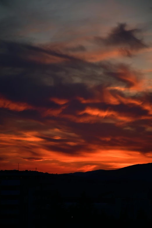 the sun is setting behind a city skyline